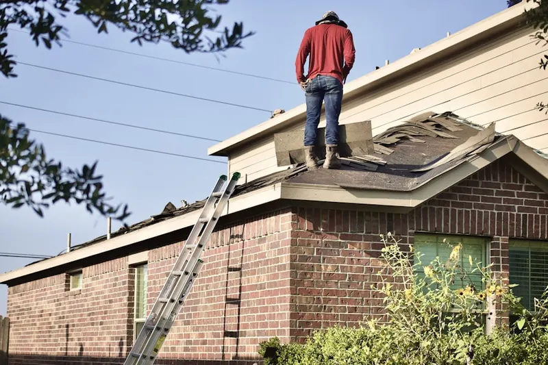 Professional roofer working on a residential roof in Old Annapolis Neck
